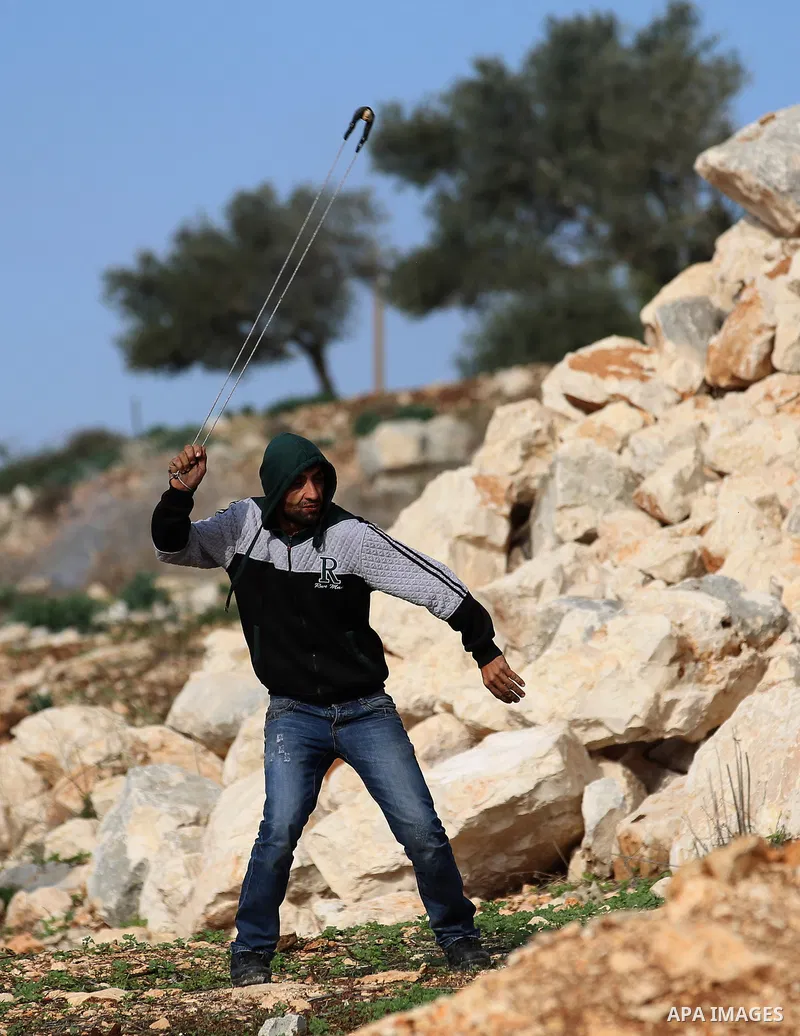 Palestinian protesters hurl stones towards Israeli forces during clashes following a weekly demonstration against the expropriation of Palestinian land by Israel in the village of Kfar Qaddum, near the West Bank city of...