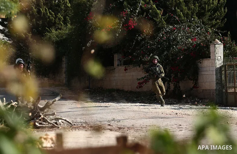 Israeli forces take position during clashes with Palestinian protesters during clashes following a weekly demonstration against the expropriation of Palestinian land by Israel in the village of Kfar Qaddum, near the West...