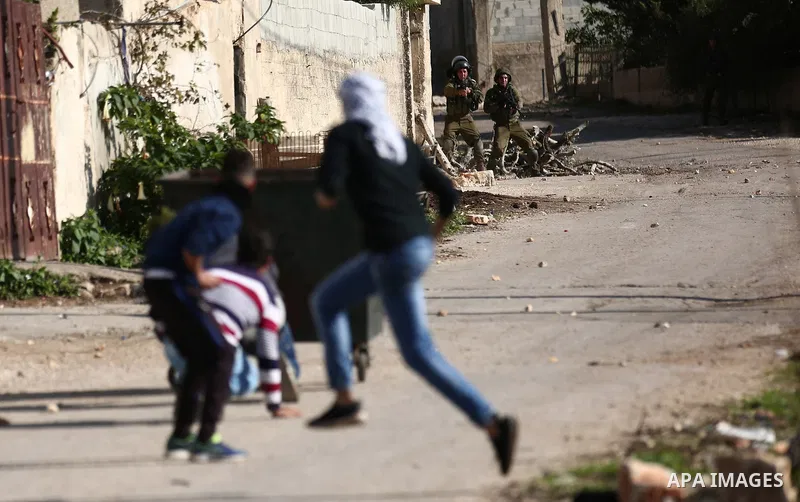 Palestinian protesters hurl stones towards Israeli forces during clashes following a weekly demonstration against the expropriation of Palestinian land by Israel in the village of Kfar Qaddum, near the West Bank city of...