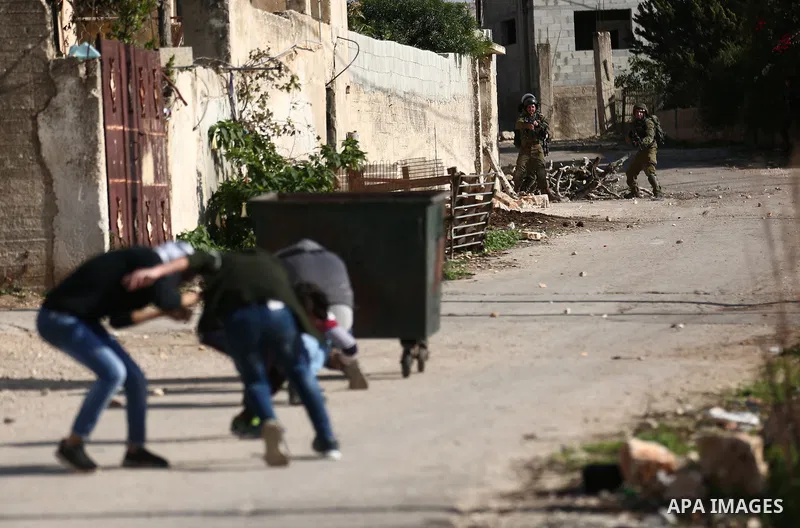 Palestinian protesters hurl stones towards Israeli forces during clashes following a weekly demonstration against the expropriation of Palestinian land by Israel in the village of Kfar Qaddum, near the West Bank city of...