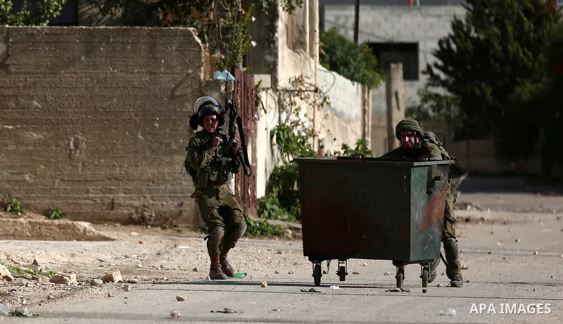 Israeli forces take position during clashes with Palestinian protesters during clashes following a weekly demonstration against the expropriation of Palestinian land by Israel in the village of Kfar Qaddum, near the West...