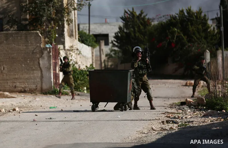Israeli forces take position during clashes with Palestinian protesters during clashes following a weekly demonstration against the expropriation of Palestinian land by Israel in the village of Kfar Qaddum, near the West...
