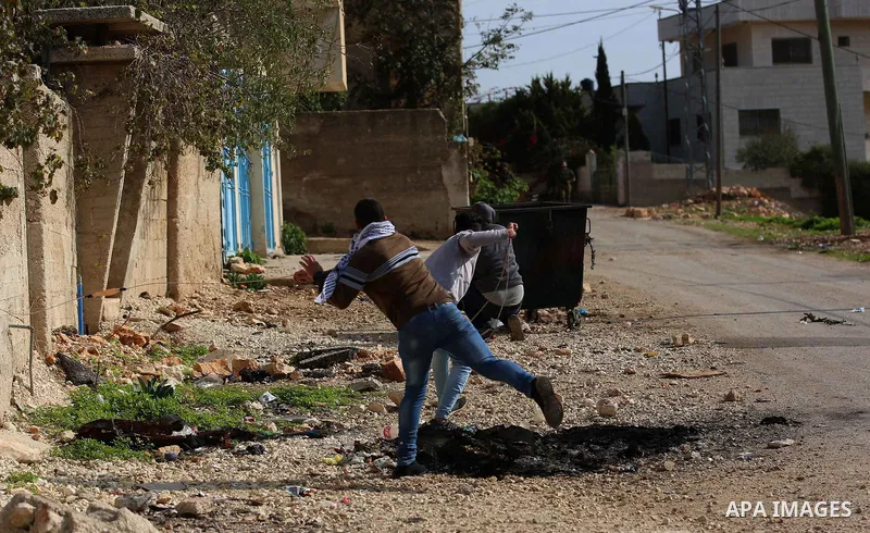 Palestinian protesters hurl stones towards Israeli forces during clashes following a weekly demonstration against the expropriation of Palestinian land by Israel in the village of Kfar Qaddum, near the West Bank city of...