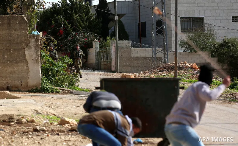 Palestinian protesters hurl stones towards Israeli forces during clashes following a weekly demonstration against the expropriation of Palestinian land by Israel in the village of Kfar Qaddum, near the West Bank city of...