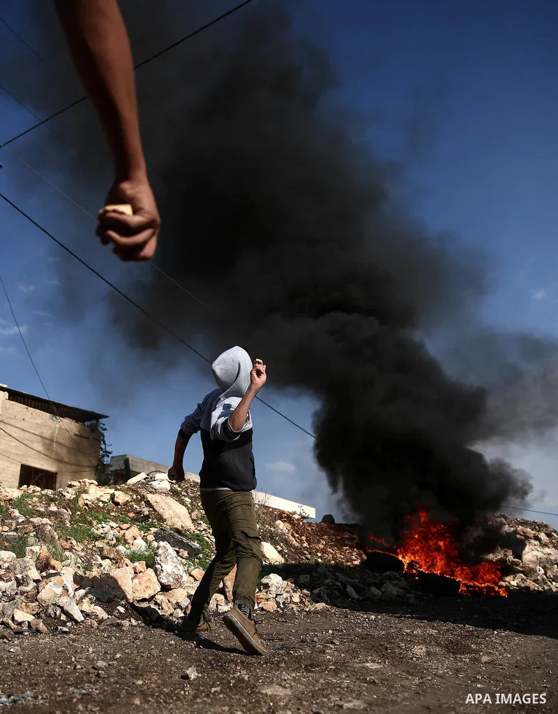 Palestinian protesters hurl stones towards Israeli forces during clashes following a weekly demonstration against the expropriation of Palestinian land by Israel in the village of Kfar Qaddum, near the West Bank city of...