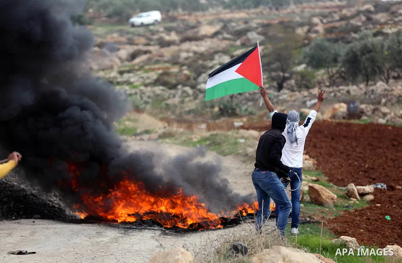 Palestinian protesters hurl stones towards Israeli forces during clashes against Israeli land seizures for Jewish settlements, in the village of al-Mughayyir, near the West Bank city of Ramallah, on November 30, 2018. Ph...