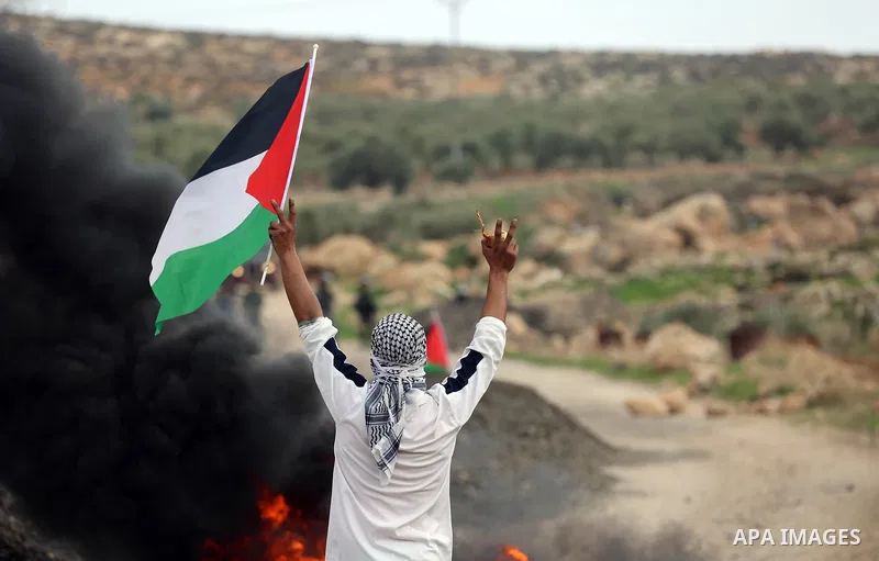 Palestinian protesters hurl stones towards Israeli forces during clashes against Israeli land seizures for Jewish settlements, in the village of al-Mughayyir, near the West Bank city of Ramallah, on November 30, 2018. Ph...