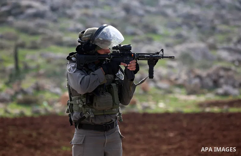 Israeli forces take position during clashes with Palestinian protesters during clashes against Israeli land seizures for Jewish settlements, in the village of al-Mughayyir, near the West Bank city of Ramallah, on Novembe...