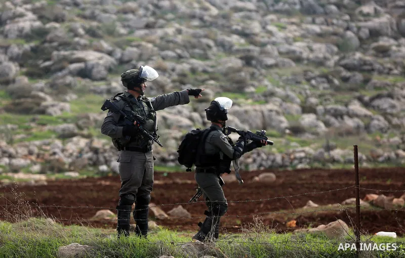 Israeli forces take position during clashes with Palestinian protesters during clashes against Israeli land seizures for Jewish settlements, in the village of al-Mughayyir, near the West Bank city of Ramallah, on Novembe...