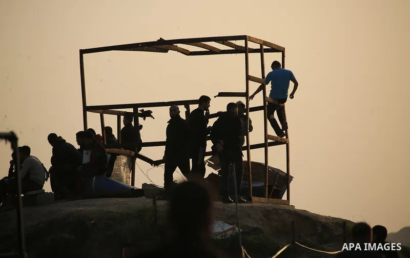 Palestinian protesters gather during clashes with Israeli troops in tents protest where Palestinians demand the right to return to their homeland at the Israel-Gaza border, in east of Gaza City on November 30, 2018. Phot...