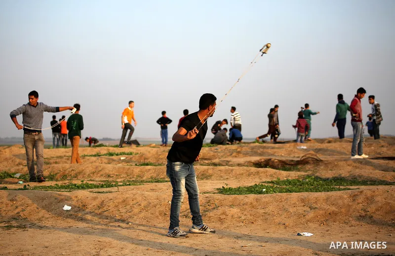 Palestinian protesters gather during clashes with Israeli troops in tents protest where Palestinians demand the right to return to their homeland at the Israel-Gaza border, in east of Gaza City on November 30, 2018. Phot...