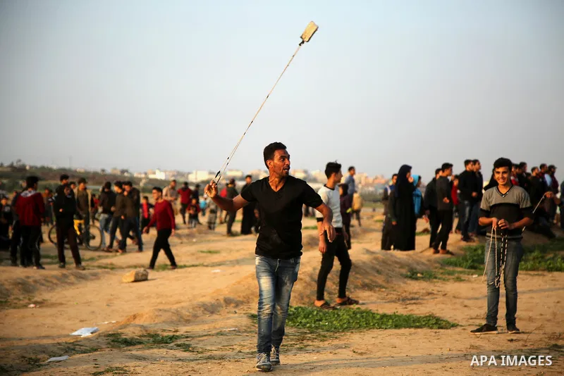 Palestinian protesters gather during clashes with Israeli troops in tents protest where Palestinians demand the right to return to their homeland at the Israel-Gaza border, in east of Gaza City on November 30, 2018. Phot...