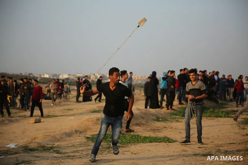 Palestinian protesters gather during clashes with Israeli troops in tents protest where Palestinians demand the right to return to their homeland at the Israel-Gaza border, in east of Gaza City on November 30, 2018. Phot...