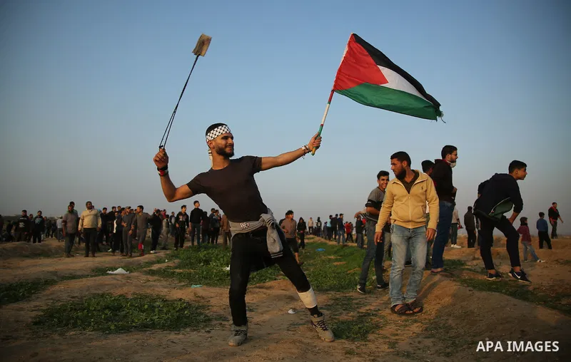 Palestinian protesters gather during clashes with Israeli troops in tents protest where Palestinians demand the right to return to their homeland at the Israel-Gaza border, in east of Gaza City on November 30, 2018. Phot...