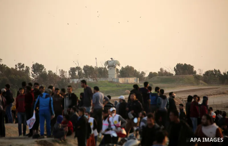 Palestinian protesters gather during clashes with Israeli troops in tents protest where Palestinians demand the right to return to their homeland at the Israel-Gaza border, in east of Gaza City on November 30, 2018. Phot...