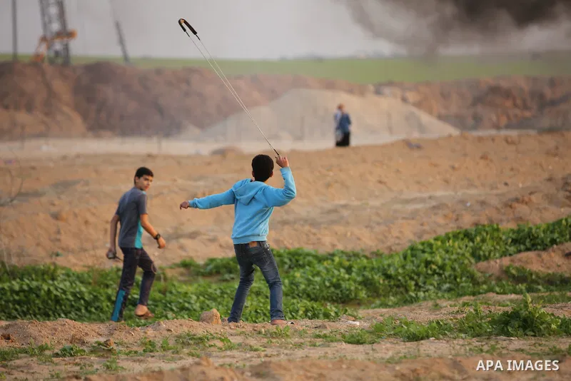 Palestinian protesters gather during clashes with Israeli troops in tents protest where Palestinians demand the right to return to their homeland at the Israel-Gaza border, in east of Gaza City on November 30, 2018. Phot...