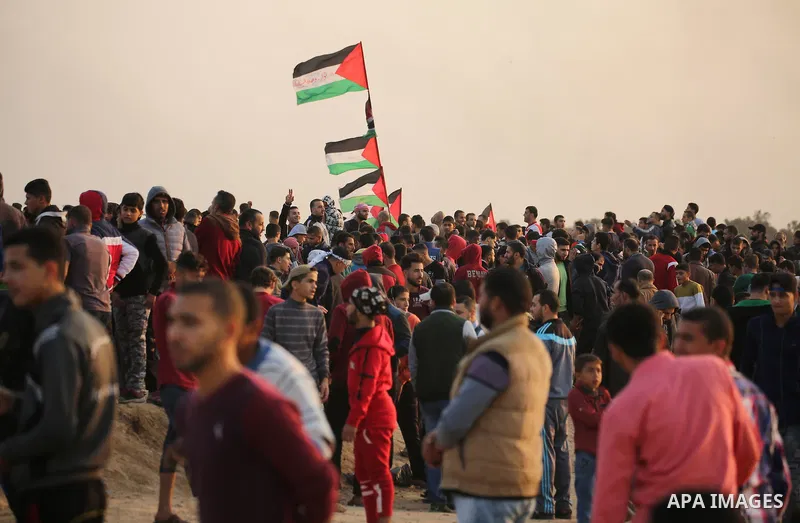 Palestinian protesters gather during clashes with Israeli troops in tents protest where Palestinians demand the right to return to their homeland at the Israel-Gaza border, in east of Gaza City on November 30, 2018. Phot...