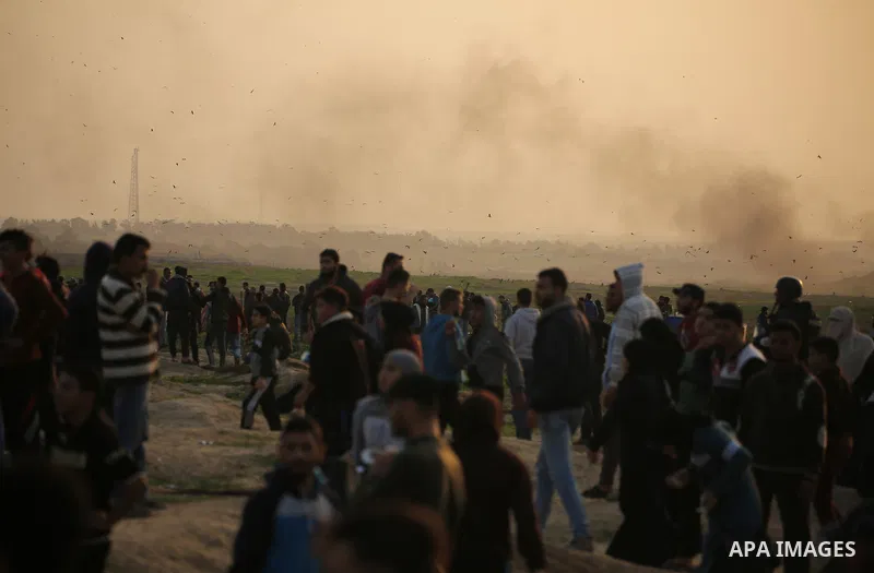 Palestinian protesters gather during clashes with Israeli troops in tents protest where Palestinians demand the right to return to their homeland at the Israel-Gaza border, in east of Gaza City on November 30, 2018. Phot...