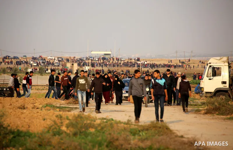 Palestinian protesters gather during clashes with Israeli troops in tents protest where Palestinians demand the right to return to their homeland at the Israel-Gaza border, in east of Gaza City on November 30, 2018. Phot...