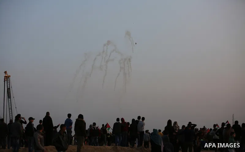 Palestinian protesters gather during clashes with Israeli troops in tents protest where Palestinians demand the right to return to their homeland at the Israel-Gaza border, in east of Gaza City on November 30, 2018. Phot...