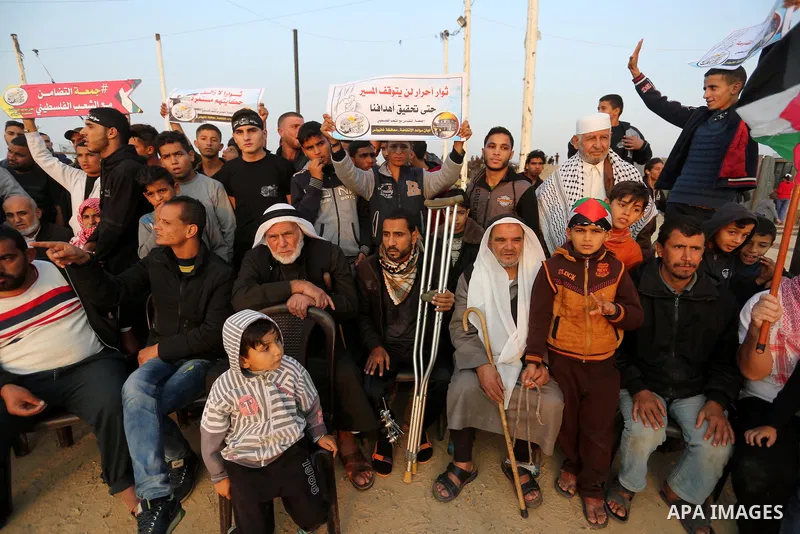 Palestinian protesters gather during tents protest where Palestinians demand the right to return to their homeland at the Israel-Gaza border, in Khan Younis in the southern Gaza Strip on November 30, 2018. Photo by Ashra...