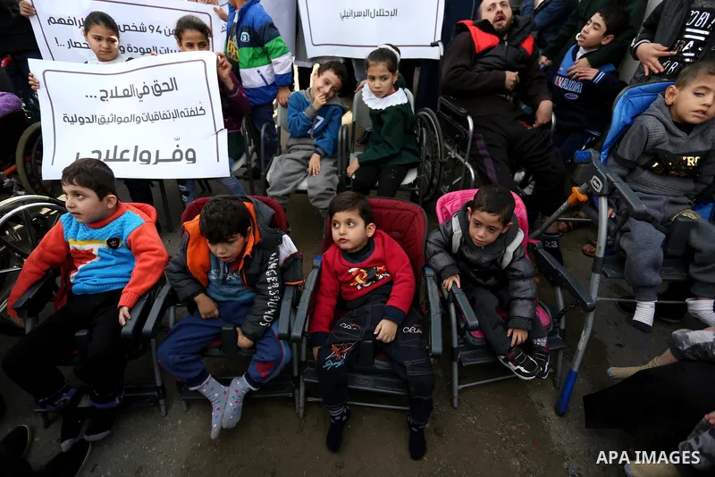 Palestinians and physically challenged people take part in a rally marking the International Day of Persons with Disabilities, in Gaza City, on December 2, 2018. Photo by Ashraf Amra