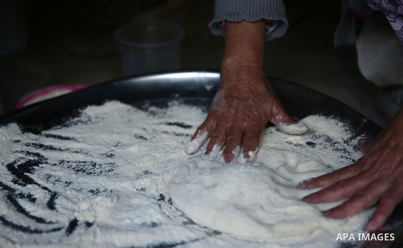 A Palestinian woman bakes traditional bread "Taboon" in the village of Salem east the West Bank City of Nablus, on December, 3, 2018. Photo by Shadi Jarar'ah