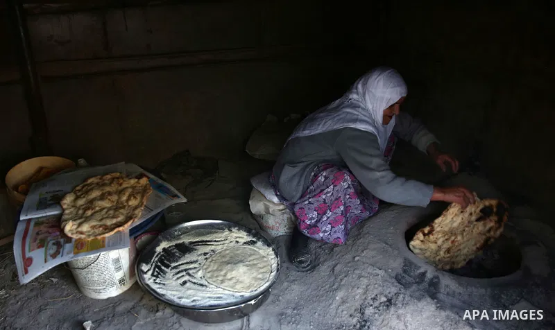 A Palestinian woman bakes traditional bread "Taboon" in the village of Salem east the West Bank City of Nablus, on December, 3, 2018. Photo by Shadi Jarar'ah