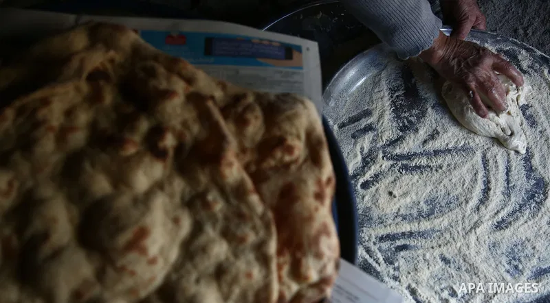 A Palestinian woman bakes traditional bread "Taboon" in the village of Salem east the West Bank City of Nablus, on December, 3, 2018. Photo by Shadi Jarar'ah