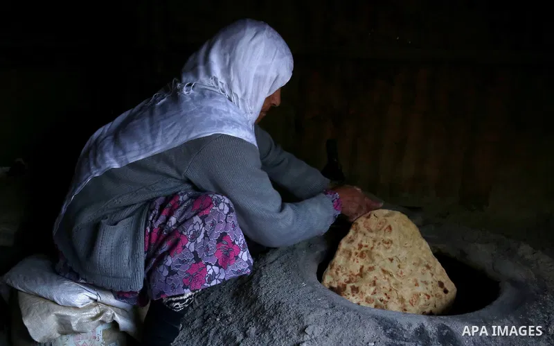 A Palestinian woman bakes traditional bread "Taboon" in the village of Salem east the West Bank City of Nablus, on December, 3, 2018. Photo by Shadi Jarar'ah