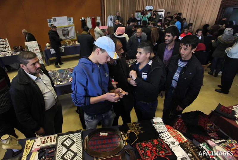 Palestinians and Disabilities attend an exhibition of handicrafts marking the International Day of Persons with Disabilities, organized by the Ministry of Culture in Gaza City on December 3, 2018. Photo by Mahmoud Ajjour
