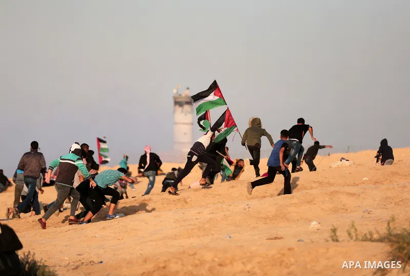Palestinian protesters gather during clashes with Israeli forces in a demonstration against the Israeli blockade on Gaza Strip, along the Gaza sea barrier on the maritime border with Israel near Kibbutz Zikim, north of B...
