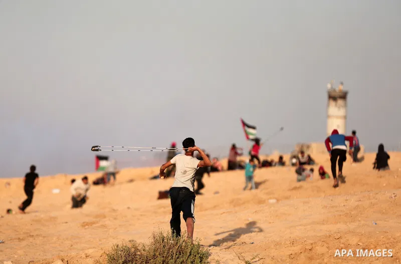 Palestinian protesters gather during clashes with Israeli forces in a demonstration against the Israeli blockade on Gaza Strip, along the Gaza sea barrier on the maritime border with Israel near Kibbutz Zikim, north of B...