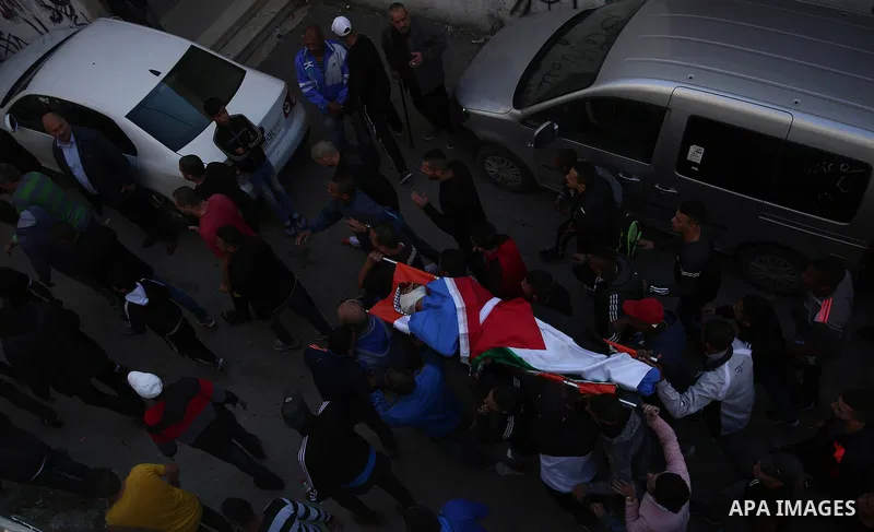Mourners carry the body of Palestinian Mohammad Habali, 22, who was shot by Israeli forces during his funeral, in the West Bank city of Tulkarem, on December 4, 2018. Habali was shot as Israeli forces raided a western ne...