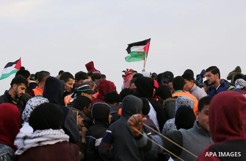 Palestinian protesters gather during clashes with Israeli troops in tents protest where Palestinians demand the right to return to their homeland at the Israel-Gaza border, in east of Gaza City on December 7, 2018. Photo...