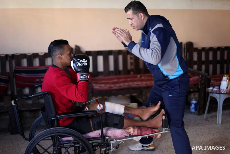 Palestinian boxer, Ahmed Abu Marahil, 20, who was shot by Israeli forces in his leg on June 2018, during a demonstration near a fence between Israel-Gaza border, attends a boxing lesson with his coach at his house in Gaz...