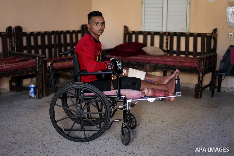 Palestinian boxer, Ahmed Abu Marahil, 20, who was shot by Israeli forces in his leg on June 2018, during a demonstration near a fence between Israel-Gaza border, attends a boxing lesson at his house in Gaza City on Decem...