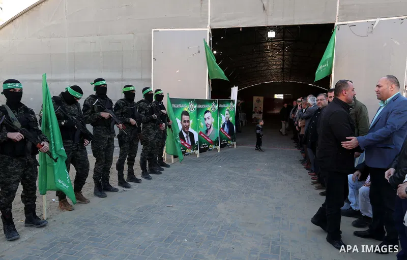 Palestinian militants of the Islamist movement Hamas' military wing Al-Qassam Brigades stand guard during a deliver consolations of three martyrs in the West Bank, in Gaza City on December 13, 2018. Photo by Mahmoud Nase...