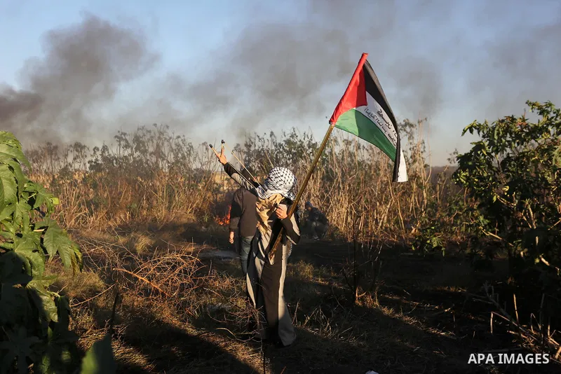 Palestinian protesters gather during clashes with Israeli troops in tents protest where Palestinians demand the right to return to their homeland at the Israel-Gaza border, in Khan Younis in the southern Gaza Strip on De...