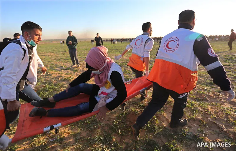 Palestinian protesters gather during clashes with Israeli troops in tents protest where Palestinians demand the right to return to their homeland at the Israel-Gaza border, in Khan Younis in the southern Gaza Strip on De...