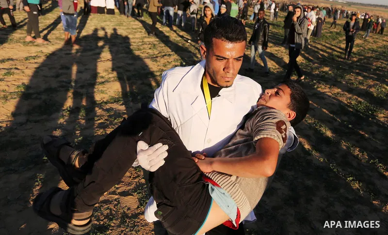 Palestinian protesters gather during clashes with Israeli troops in tents protest where Palestinians demand the right to return to their homeland at the Israel-Gaza border, in Khan Younis in the southern Gaza Strip on De...
