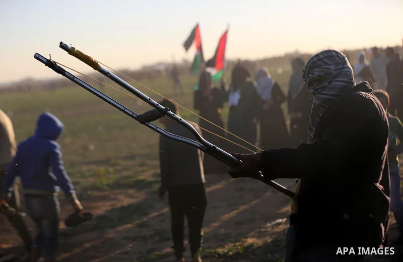 Palestinian protesters gather during clashes with Israeli troops in tents protest where Palestinians demand the right to return to their homeland at the Israel-Gaza border, in Khan Younis in the southern Gaza Strip on De...