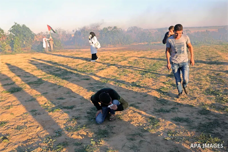Palestinian protesters gather during clashes with Israeli troops in tents protest where Palestinians demand the right to return to their homeland at the Israel-Gaza border, in Khan Younis in the southern Gaza Strip on De...