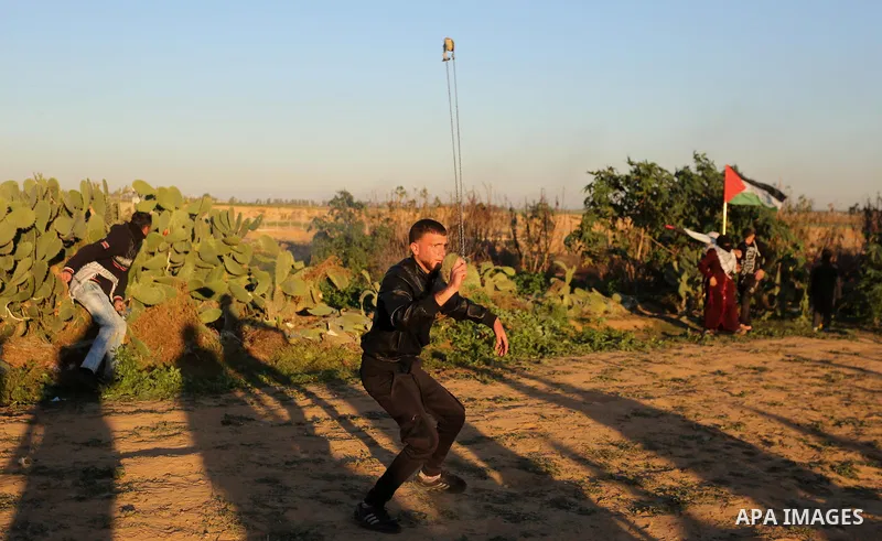Palestinian protesters gather during clashes with Israeli troops in tents protest where Palestinians demand the right to return to their homeland at the Israel-Gaza border, in Khan Younis in the southern Gaza Strip on De...