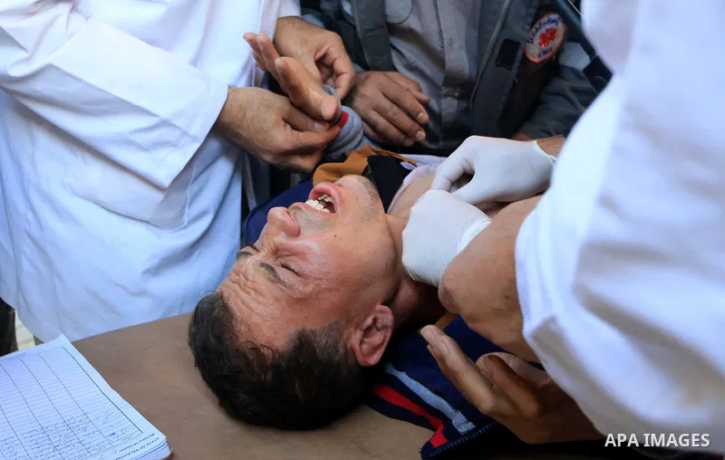 Palestinian protesters gather during clashes with Israeli troops in tents protest where Palestinians demand the right to return to their homeland at the Israel-Gaza border, in al-Bureij in the center of Gaza Strip on Dec...