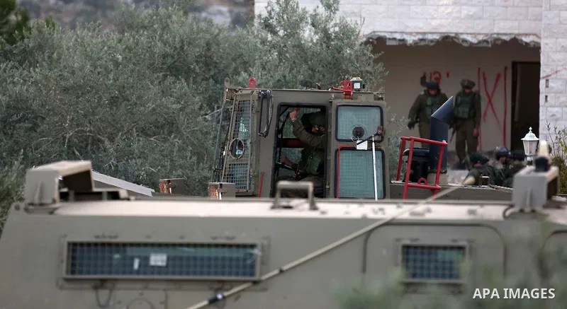 Israeli soldiers take position as an excavator destroys the house of Palestinian man Ashraf Naalwa in the village of Shuwaykah, near the West Bank city of Tulkarem, on December 17, 2018. Ashraf Naalwa was killed on Decem...