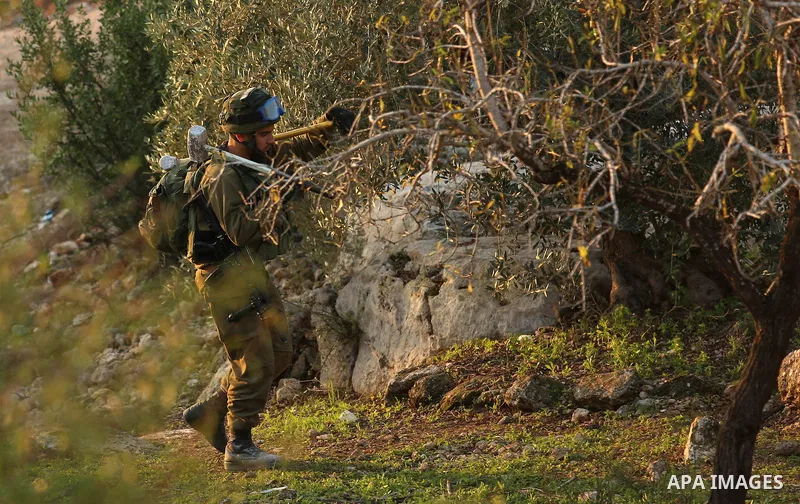 Israeli soldiers take position as an excavator destroys the house of Palestinian man Ashraf Naalwa in the village of Shuwaykah, near the West Bank city of Tulkarem, on December 17, 2018. Ashraf Naalwa was killed on Decem...