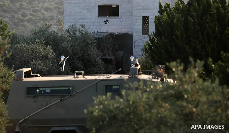 An excavator of the Israeli forces destroys the house of Palestinian man Ashraf Naalwa in the village of Shuwaykah, near the West Bank city of Tulkarem, on December 17, 2018. - Ashraf Naalwa was killed on December 12 by...