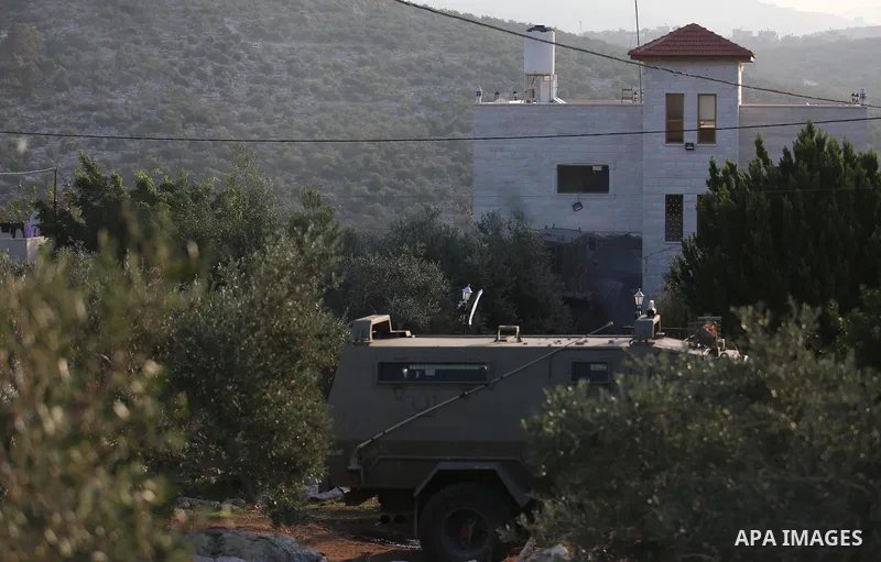 An excavator of the Israeli forces destroys the house of Palestinian man Ashraf Naalwa in the village of Shuwaykah, near the West Bank city of Tulkarem, on December 17, 2018. - Ashraf Naalwa was killed on December 12 by...