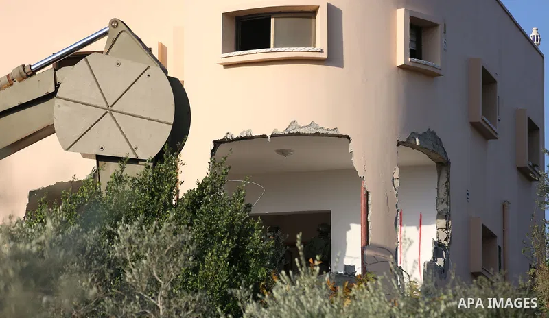An excavator of the Israeli forces destroys the house of Palestinian man Ashraf Naalwa in the village of Shuwaykah, near the West Bank city of Tulkarem, on December 17, 2018. - Ashraf Naalwa was killed on December 12 by...